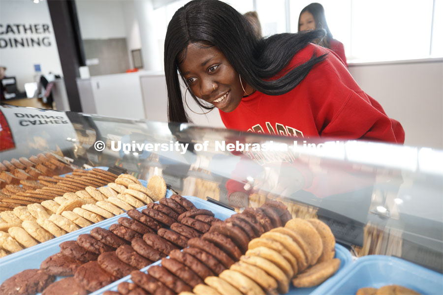 Cather Dining Center photoshoot. A young woman choosing a cookie. March 2, 2020 Photo by Craig Chandler / University Communication.