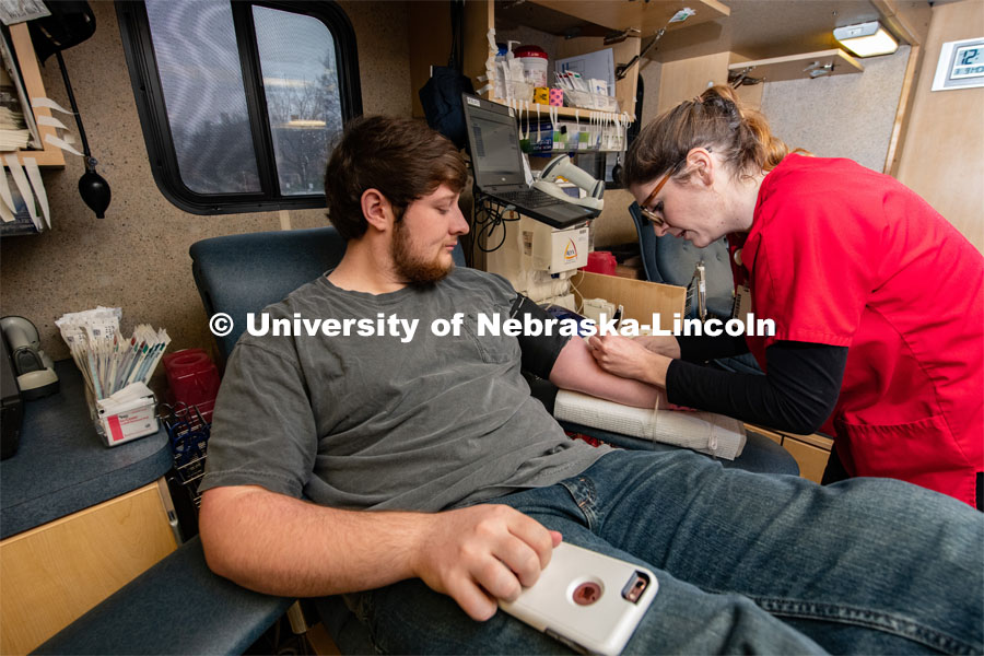 Kelsey, of the Community Blood Bank, preps Student Ryan Wiese of Grand Island, an Agribusiness Senior, to donate Blood. March 9, 2020. Photo by Gregory Nathan / University Communication.