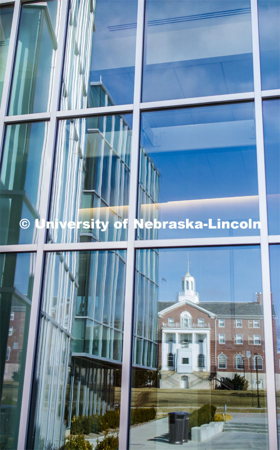 Neihart Hall is reflected in the new Willa Cather Dining Complex on City Campus. March 17, 2020. Photo by Craig Chandler / University Communication.