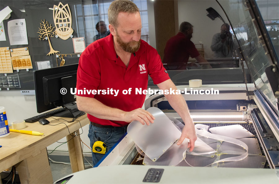 Jerry Reif, shop manager at Nebraska Innovation Studio, works on a laser to cut clear plastic sheeting for face shields. The face shields are being assembled for hospitals in Nebraska in response to COVID-19. April 1, 2020. Photo by Gregory Nathan / University Communication.