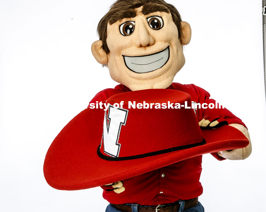 Herbie Husker holding his hat in the photo studio. April 10, 2020. Photo by Craig Chandler / University Communication.