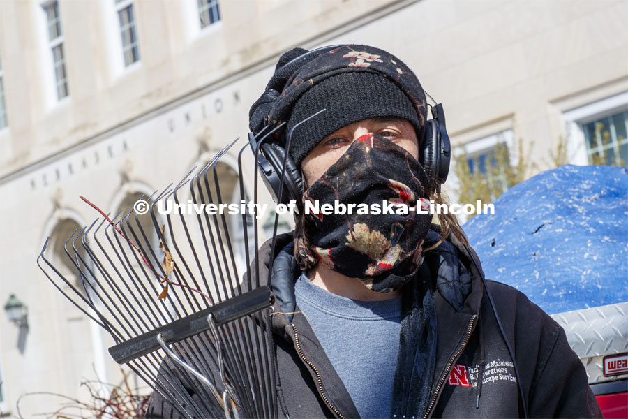 Ryan LaBenz, a Landscape Service student worker, wears a mask while working outside the Nebraska Union. He is one of many students still working on campus. April 13, 2020. Photo by Craig Chandler / University Communication.