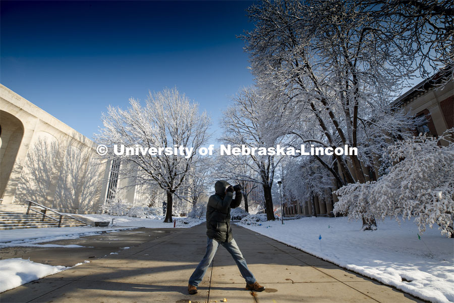 Chad Davis with Nebraska Educational Television takes a photo walk on city campus Friday morning. An April snowstorm leaves campus unseasonably beautiful. April 17, 2020. Photo by Craig Chandler / University Communication.