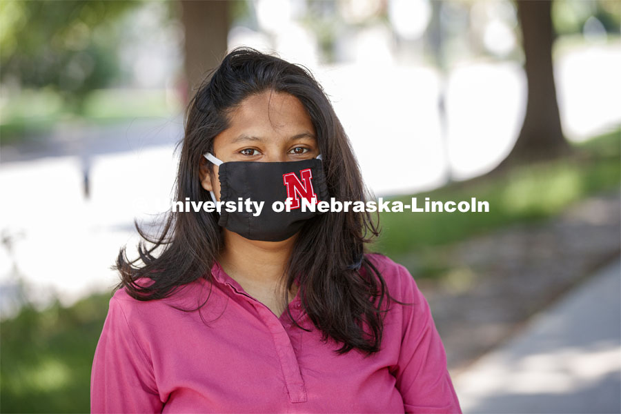 Asmita Jayswal, junior in computer science, models the new N mask. More than 60,000 face masks are to be distributed to all students, faculty and staff for the fall semester. June 26, 2020. Photo by Craig Chandler / University Communication.