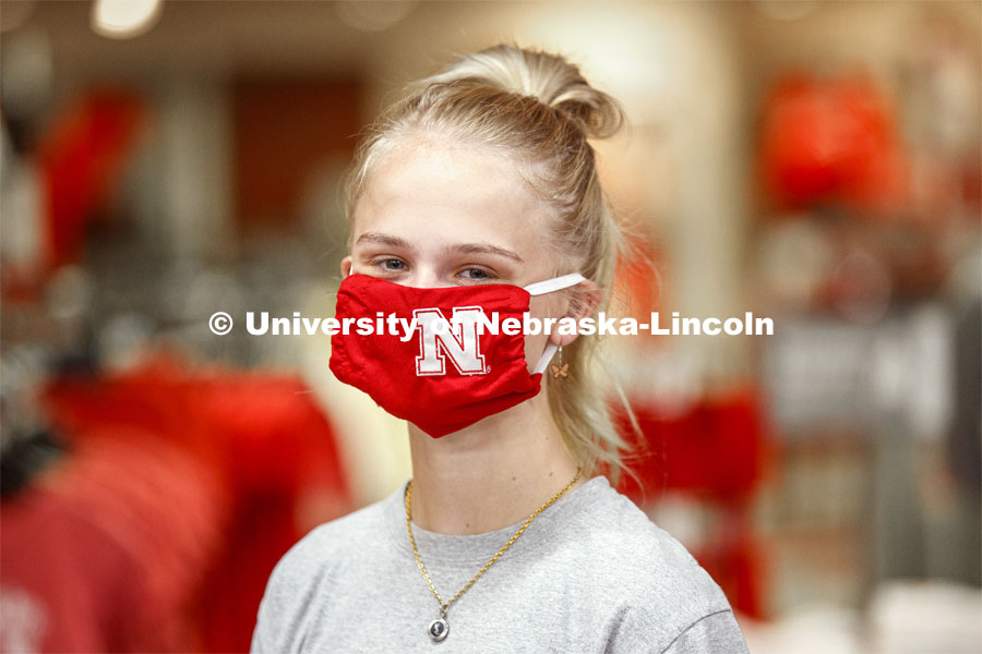 Sophia Merrill, an incoming freshman from Chanhassen, MN, models the new N mask.  Merrill was shopping in the Nebraska Union bookstore with her family. More than 60,000 face masks are to be distributed to all students, faculty and staff for the fall semester. June 26, 2020. Photo by Craig Chandler / University Communication.