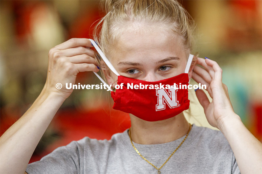 Sophia Merrill, an incoming freshman from Chanhassen, MN, tries on her new N mask. Merrill was shopping in the Nebraska Union bookstore with her family. More than 60,000 face masks are to be distributed to all students, faculty and staff for the fall semester. June 26, 2020. Photo by Craig Chandler / University Communication.
