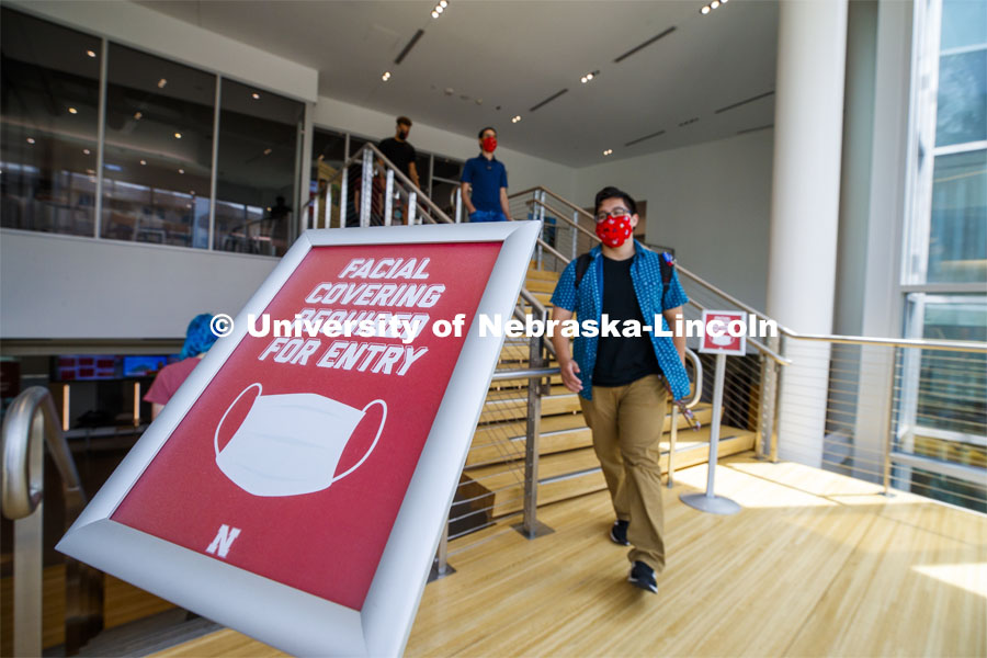 A sign by the stairwell in the Willa Cather complex tells students to wear masks upon. Photo shoot of students wearing masks and practicing social distancing in dining services in Willa Cather Dining Center. July 1, 2020. Photo by Craig Chandler / University Communication.