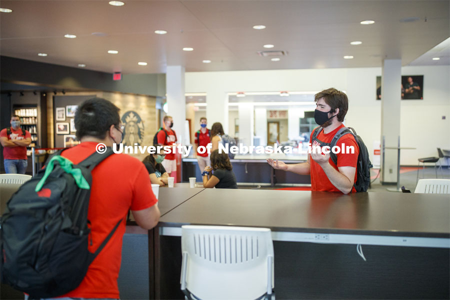 Photo shoot of students on city campus display mask wearing, social distancing. Students wearing masks while sitting together in the Nebraska Union. August 5, 2020. Photo by Craig Chandler / University Communication.