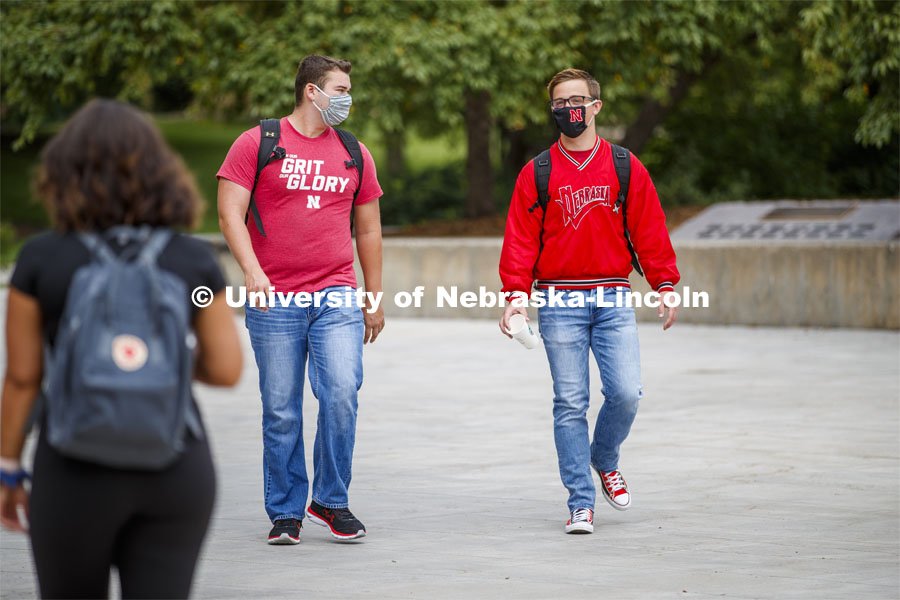 Photo shoot of students on city campus display mask wearing, social distancing. Two young men wearing masks visit while keeping a safe distance apart. August 5, 2020. Photo by Craig Chandler / University Communication.