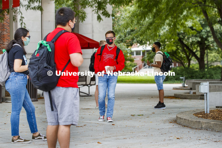 Photo shoot of students on city campus display mask wearing and social distancing. Students wear masks while socializing in the commons area outside the Nebraska Union. August 5, 2020. Photo by Craig Chandler / University Communication.