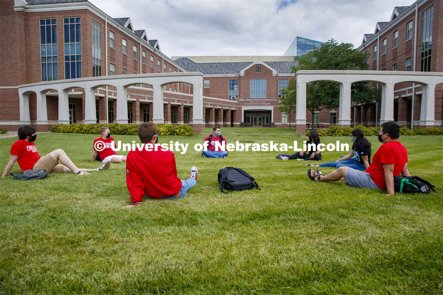 Photo shoot of students on city campus display mask wearing and social distancing. Students lounge on the grass outside Kauffman, all while maintaining a social distance. August 5, 2020. Photo by Craig Chandler / University Communication.