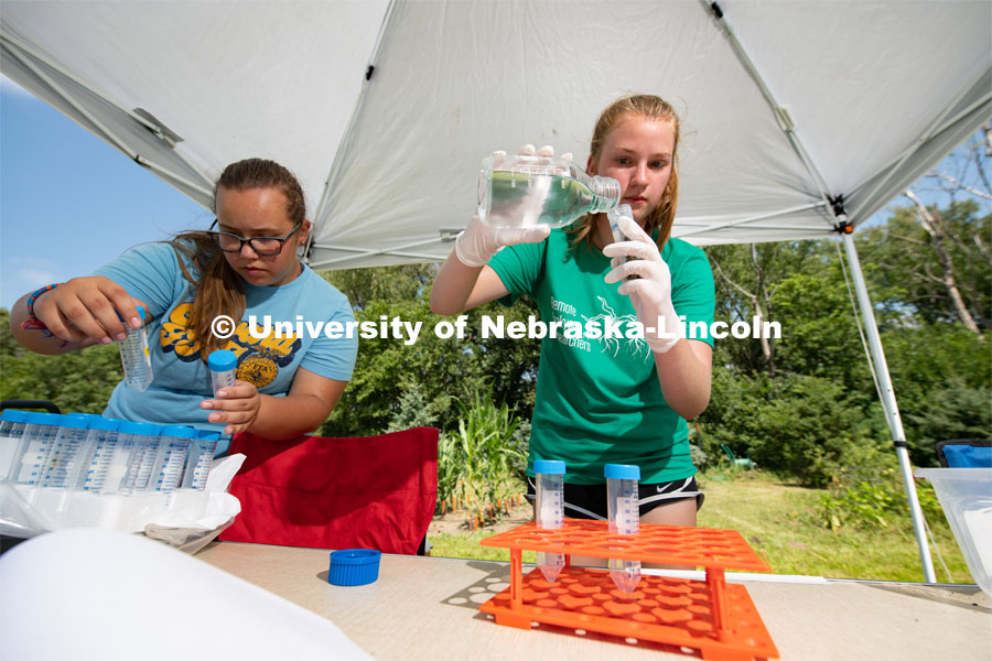 Natalie Keller and Remi Christensen prepare corn roots for cutting then washing. They will be taking samples of the microorganisms in the soil that will later be studied and compared to different soils across Nebraska. The girls are a part of the Plant Class which they are taking though Seward Highschool, Biochemistry and EPSCOR. The high school soil science camp that was originally to be held on campus was reimagined, so participants did the research in their own yards. August 6, 2020. Photo by Gregory Nathan / University Communication.