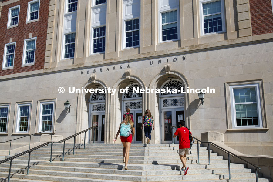Students wearing masks as they enter the Nebraska Union on City Campus. Photo shoot of students wearing masks and practicing social distancing.  August 11, 2020 Photo by Craig Chandler / University Communication