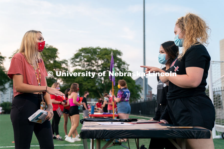 Members of the Nebraska Barbell Club (right) speak to a student during the HuskerMania Masker Singer event at Mabel Lee Fields. August 21, 2020. Photo by Jordan Opp for University Communication.