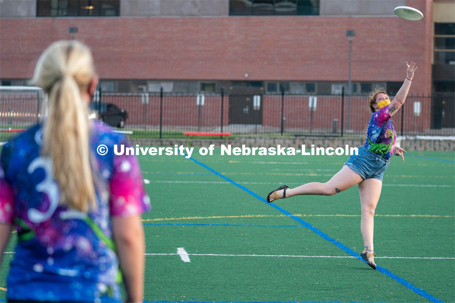 Michaela Ott (left) and Sierra Schuman (right) throw a frisbee back and forth before the start of the HuskerMania Masker Singer event at Mabel Lee Fields. August 21, 2020. Photo by Jordan Opp for University Communication.