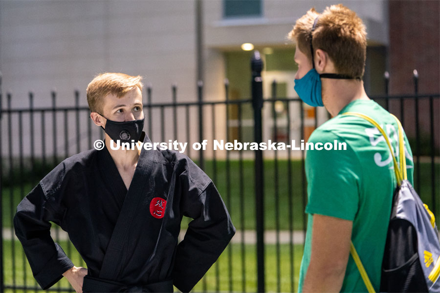 A member of the Nebraska Judo Club speaks to a student during the HuskerMania Masker Singer event at Mabel Lee Fields. August 21, 2020. Photo by Jordan Opp for University Communication.
