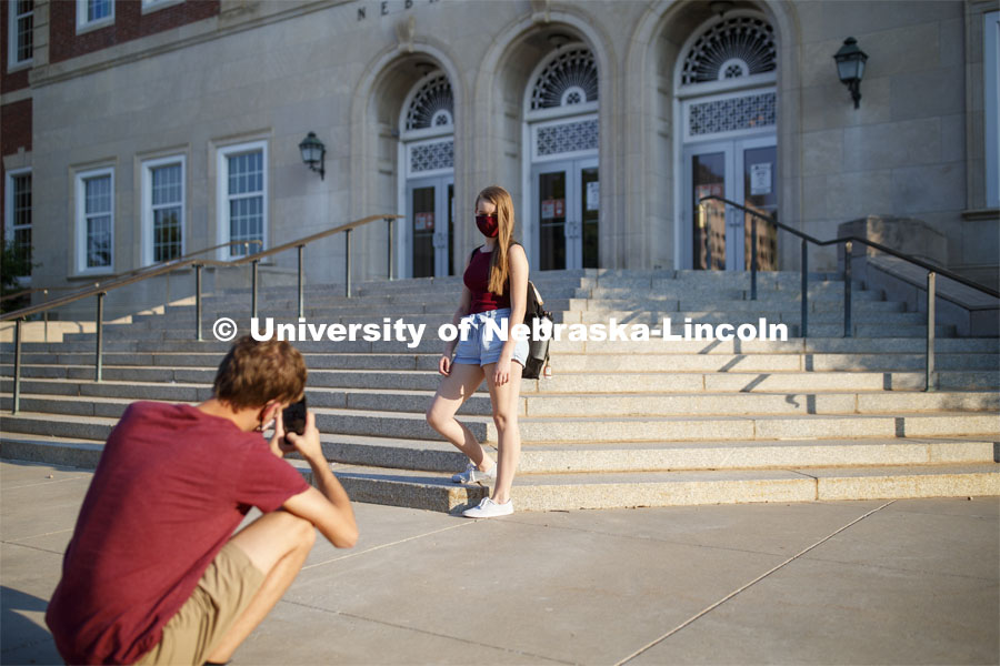 Alyssa Johnson has her photo taken by Tanner Huber in front of the Nebraska Union as the two walk to class. First day for in-person learning for the fall semester. August 24, 2020. Photo by Craig Chandler / University Communication.