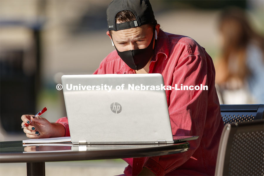 Evan Brende of Renner, South Dakota, studies outside Love Library in the morning sun. First day for in-person learning for the fall semester. August 24, 2020. Photo by Craig Chandler / University Communication.