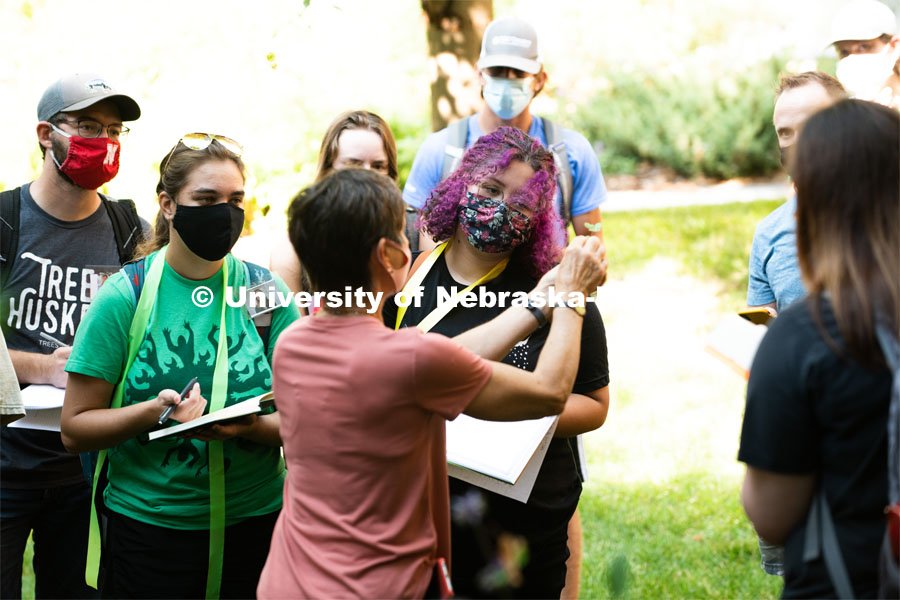 Deanne Moutanez gets a closeup view as Kim Todd displays a leaf from a plant in her Hort 214 Herbaceous id class. First day of in-person learning for the fall semester. August 24, 2020. Photo by Greg Nathan / University Communication.