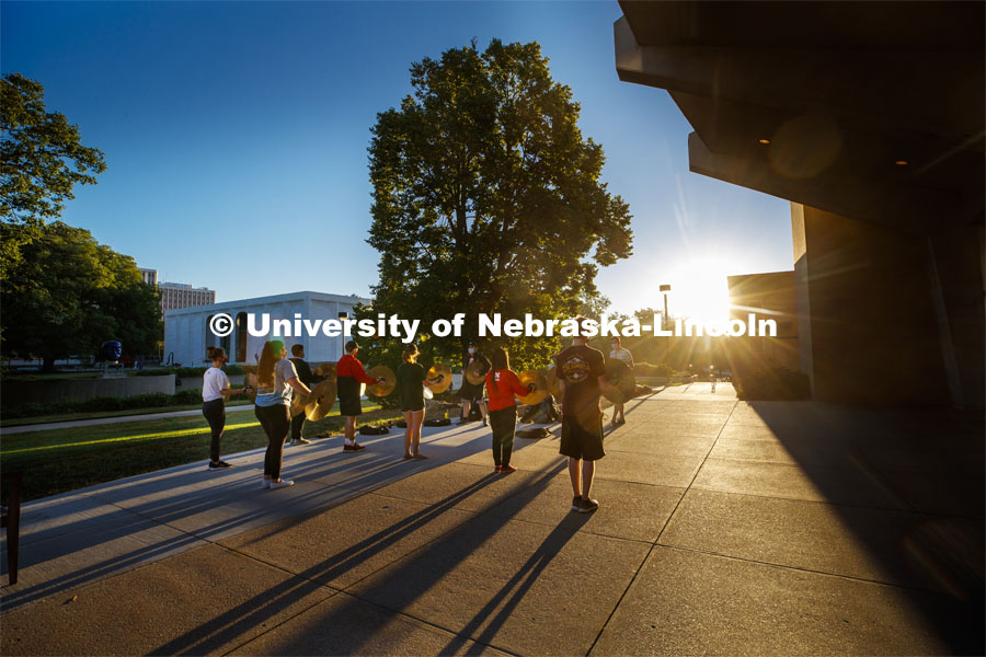 A sunrise serenade as the cymbals and bass line of the Cornhusker Marching Band practices outside Kimball Music Hall Tuesday morning, September 2, 2020. Photo by Craig Chandler / University Communication.