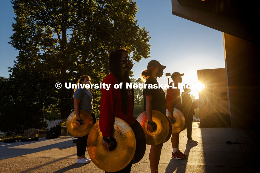 A sunrise serenade as the cymbals and bass line of the Cornhusker Marching Band practices outside Kimball Music Hall Tuesday morning, September 2, 2020. Photo by Craig Chandler / University Communication.