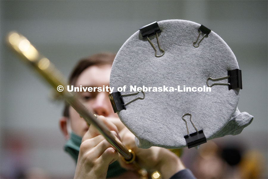 Band members have used ingenuity to cover their horn's bell. Cornhusker Marching Band practice in Cook Pavilion. September 10, 2020. Photo by Craig Chandler / University Communication.