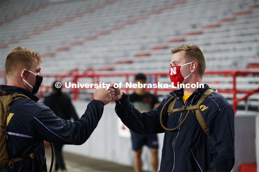 Midshipmen Christian New, left, and Chris Haidvogel fist bump after completing the run. UNL ROTC cadets and Lincoln first responders run the steps of Memorial Stadium to honor those who died on September 11. Each cadet ran more than 2,000 steps. September 11, 2020. Photo by Craig Chandler / University Communication.