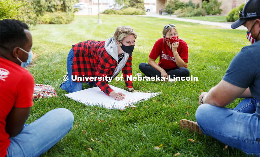 Madisen Randa writes down strategies her group brainstormed during class. Assistant Professor Andrea Basche teachers her AGRO 405 - Crop Management Strategies class in the green space west of the Plant Sciences Hall. September 17, 2020. Photo by Craig Chandler / University Communication.