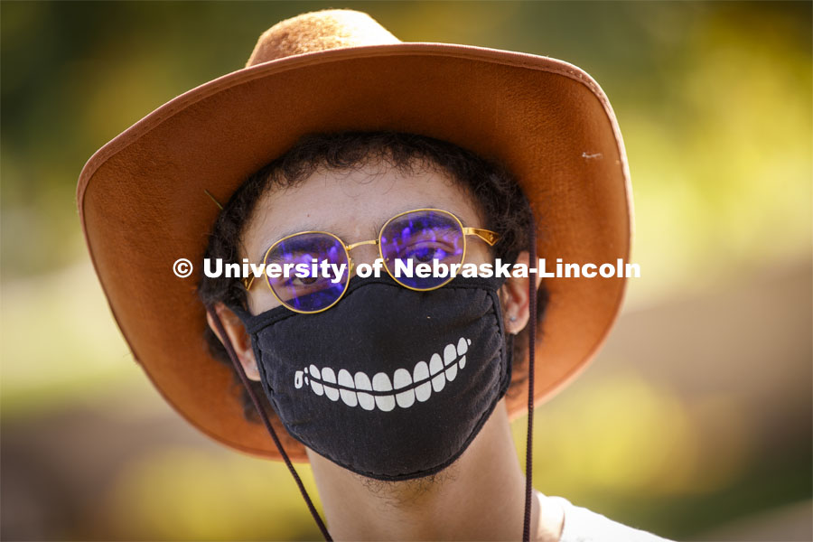 Daniel Pinto wears a smile on his mask. Sharon Kuska's ARCH 231 - Structural Fundamentals class had to build a structure that promotes social distancing using structural fundamentals and sustainable materials. September 22, 2020. Photo by Craig Chandler / University Communication.