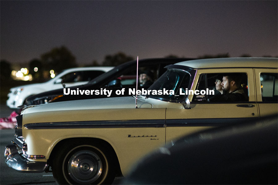 Joe Horacek and Katie Nieland enjoy popcorn before the beginning of “The Art of Dissent."  They drove what they said was the perfect car to go to a drive-in movie; a 1955 Chrysler Windsor Deluxe. The northwest corner of Nebraska Innovation Campus was the site for a drive-in movie showing “The Art of Dissent,” a feature documentary film by historian James Le Sueur. The film explores the role of artistic activism during Czechoslovakia’s communist takeover and nonviolent transition from communist power. September 30, 2020. Photo by Craig Chandler / University Communication.