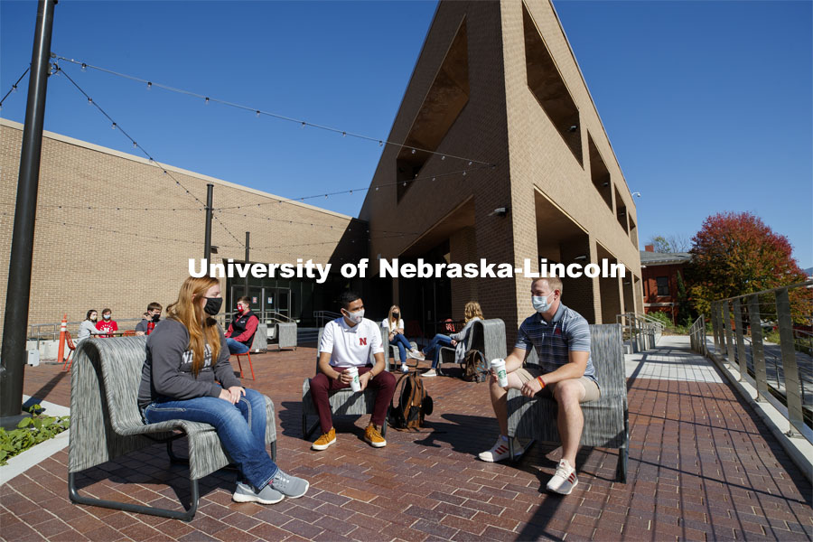 Students sit on the new patio along the south side of the Nebraska East Union. East Campus photo shoot. October 13, 2020. Photo by Craig Chandler / University Communication.
