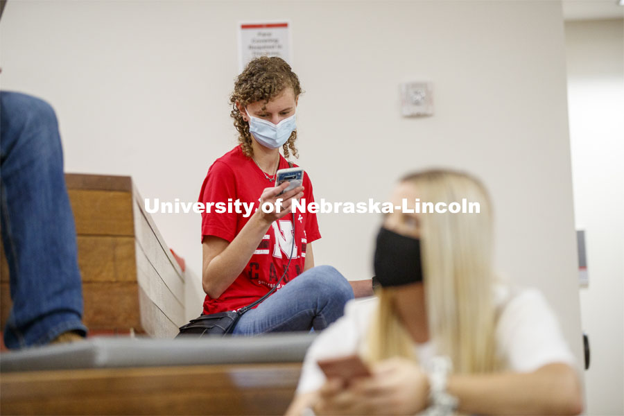 Students checking their phones inside the remodeled Nebraska East Union. East Campus photo shoot. October 13, 2020. Photo by Craig Chandler / University Communication.