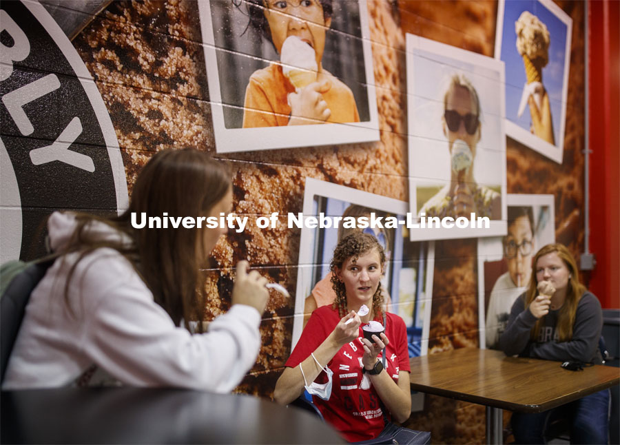 Students enjoy ice cream while social distancing inside the Dairy Store. East Campus photo shoot. October 13, 2020. Photo by Craig Chandler / University Communication.