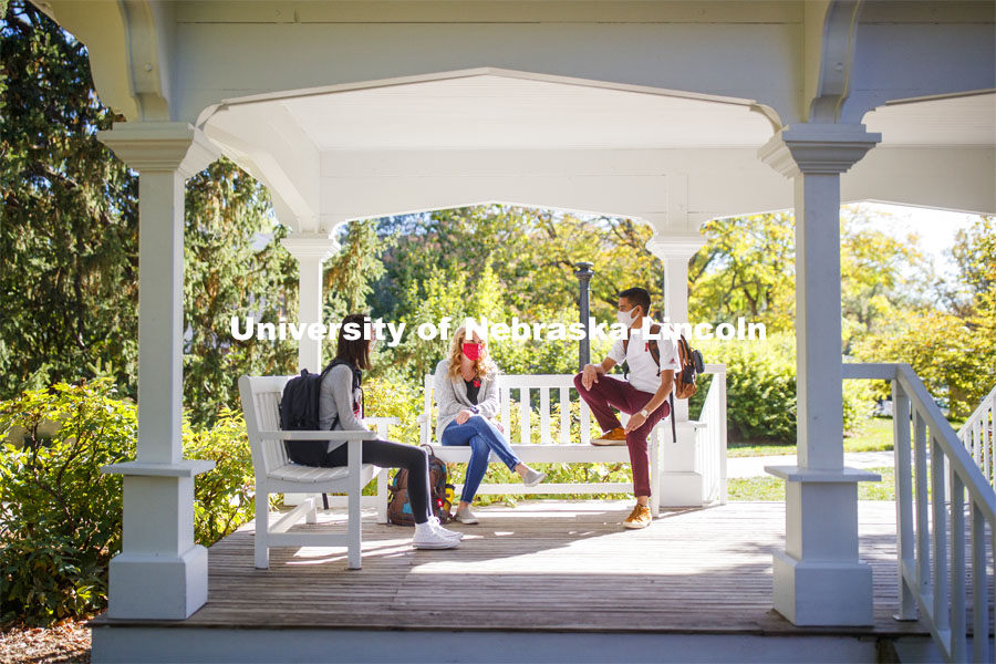 Tori Huffman, Sydney Brewer, and Sushant Timalsina enjoy the afternoon on Perin Porch on east campus. East Campus photo shoot. October 13, 2020.  Photo by Craig Chandler / University Communication