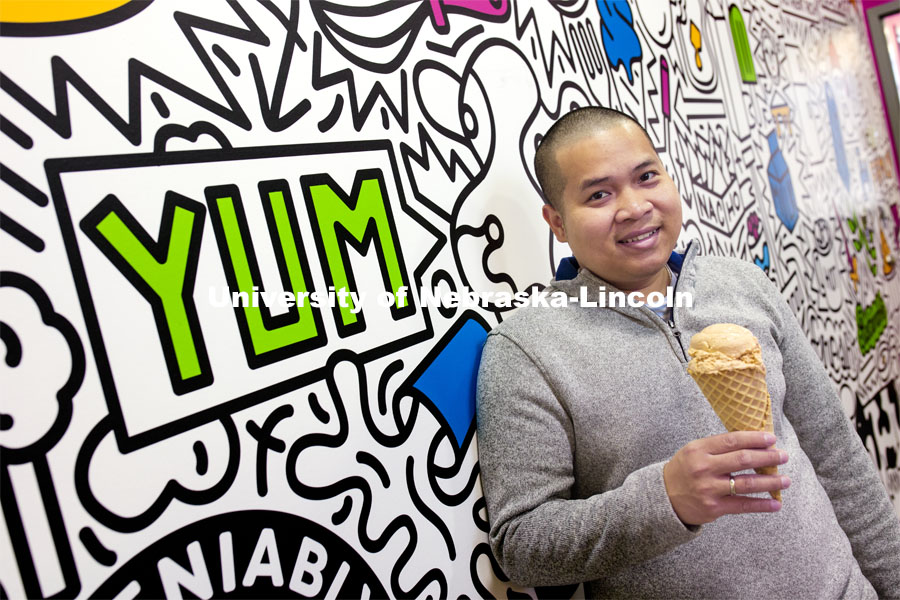 Duy Nguyen holds a cone of his favorite flavor, Butterscotch Frost. Duy Nguyen is the manager of the Dairy Store. February 26, 2021. Photo by Craig Chandler / University Communication.