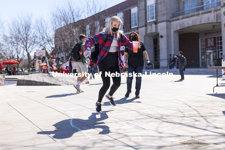 Brenna Paul shows her hopscotch form at the Spring Breakout Festival. Students have fun at the Spring Breakout, a midday festival with free games, music, and prizes. 300 free t-shirts for participants. March 29, 2021. Photo by Craig Chandler / University Communication.