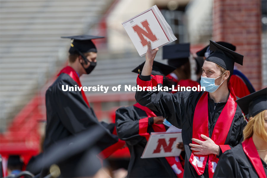 Jack Troy gestures to family and friends after receiving his CASNR degree in turfgrass and landscape management. UNL Commencement in Memorial Stadium. May 8, 2021. Photo by Craig Chandler / University Communication.