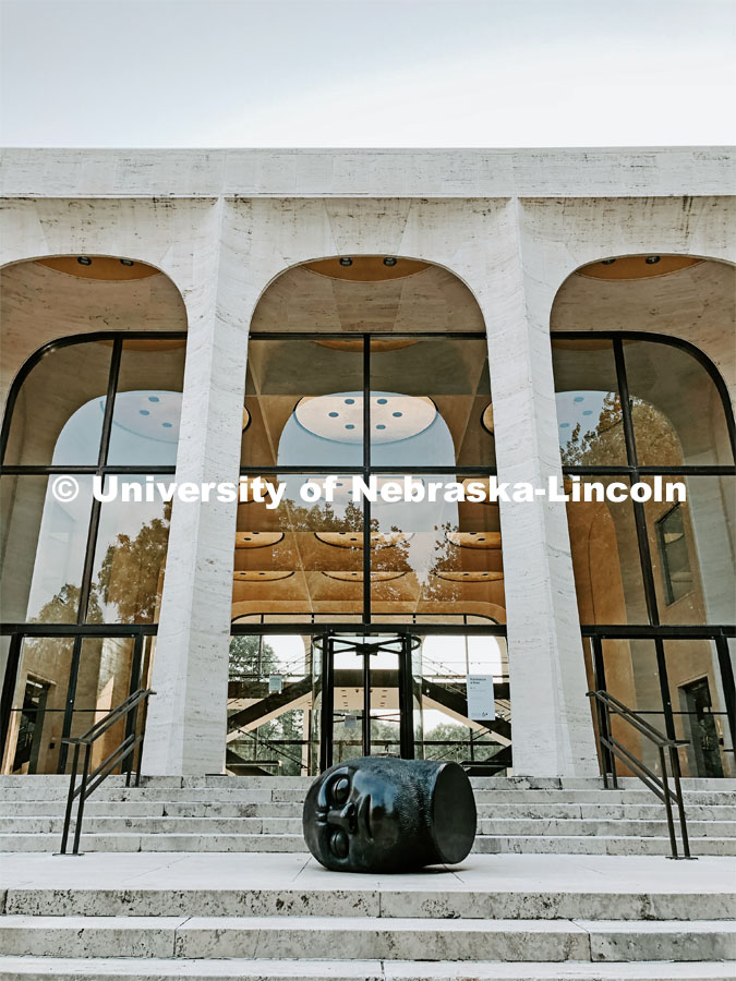 The Fallen Dreamer head sculpture lays on the front steps of the Sheldon Memorial Art Gallery on City Campus. July 21, 2021. Photo by Katie Black / University Communication.