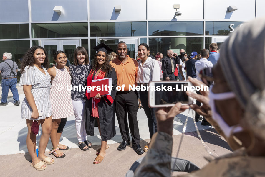 Noele Smith poses for her grandmother outside of Pinnacle Bank Arena. Undergraduate Commencement at Pinnacle Bank Arena. August 14, 2021. Photo by Craig Chandler / University Communication.