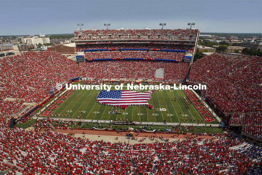 A US flag in the shape of the lower 48 states filled 50 yards of Tom Osborne Field for the national anthem. Nebraska vs. Buffalo University game on the 20th anniversary of 9/11. Photo by Joscelyn Hynes / Husker Athletics.