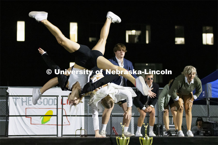 Taryn Dimmit and Hannah Fjeldheim flip during their performance. Triad 7—Alpha Gamma Sigma, Chi Phi, Delta Gamma and Pi Kappa Phi, perform. Showtime at the Vine Street Fields. Recognized Student Organizations, Greeks and Residence Halls battle against each other with performances for Homecoming competition points and ultimate bragging rights. September 27, 2021. Photo by Craig Chandler / University Communication.