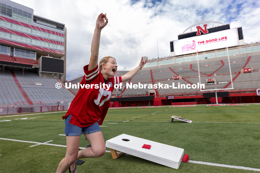 Abi Schoup, a senior on the mortar board team, reacts after scoring a cornhole. Homecoming Cornhole Tournament. Teams of two square off against each other in the classic lawn game of cornhole in Memorial Stadium. September 29, 2021. Photo by Craig Chandler / University Communication.