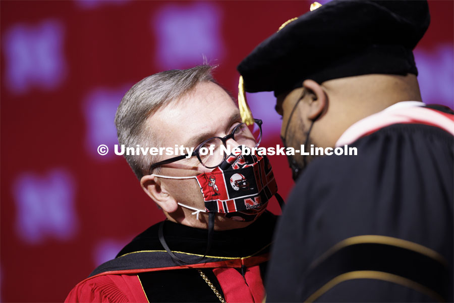 Chancellor Ronnie Green congratulates Alfonzo Cooper, Jr., a 2020 music doctorate, after his hooding. Graduate Commencement at Pinnacle Bank Arena. December 17, 2021. Photo by Craig Chandler / University Communication.