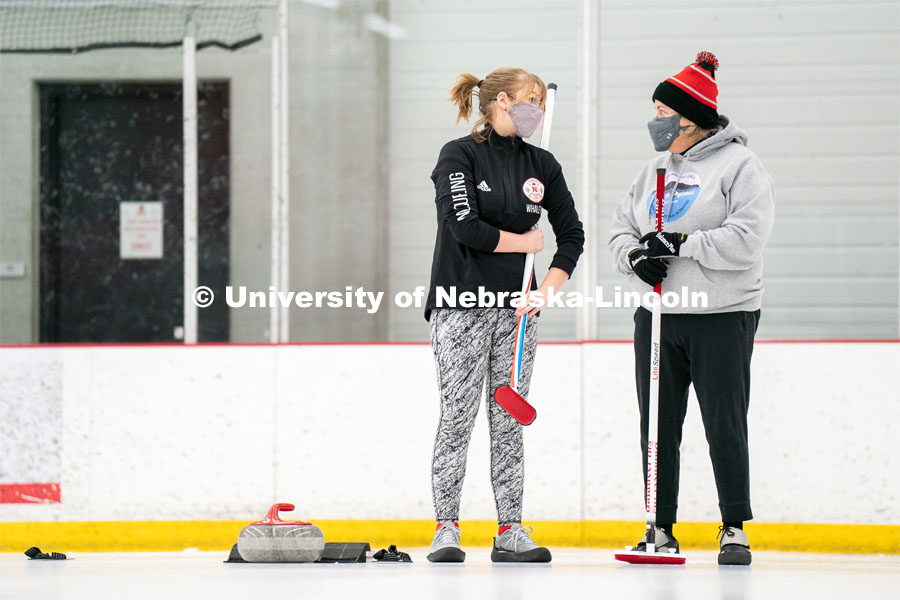 University of Nebraska Curling Club adviser Nancy Myers (right) and Emma Whaley (left) speak to each other during practice at the John Breslow Ice Hockey Center. Curling Club. February 1, 2022. Photo by Jordan Opp for University Communication.