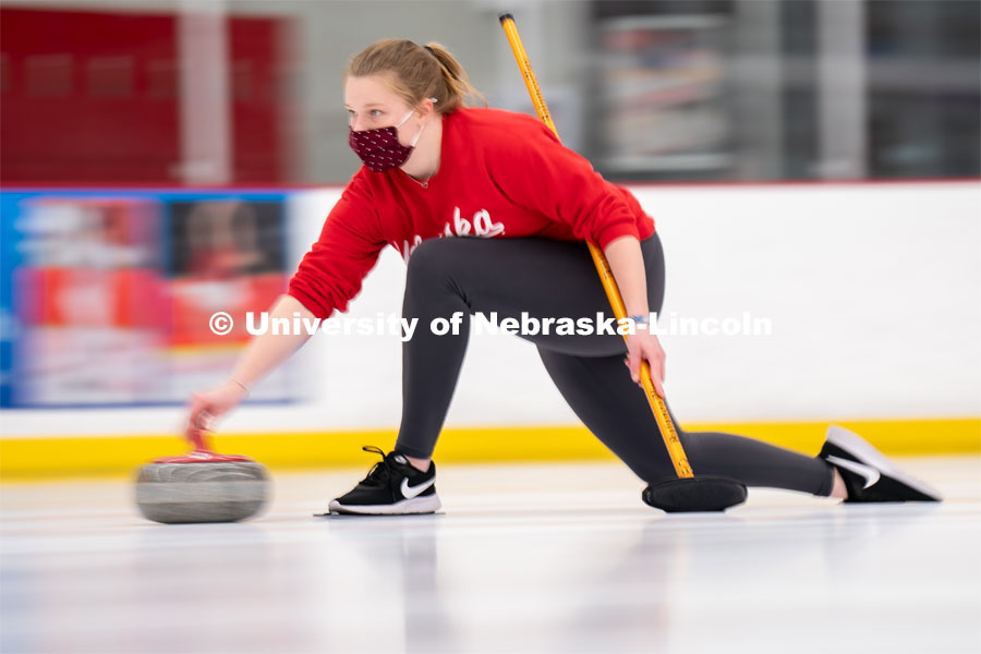 Olivia Schuster serves during curling practice at the John Breslow Ice Hockey Center. Curling Club. February 1, 2022. Photo by Jordan Opp for University Communication.