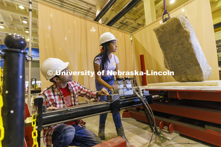 Mohammadreza Farooghi Mehr and Gabriela Yáñez position a slab on a large shake table in Christine Wittich’s structures lab in Scott Engineering Center. College of Engineering photo shoot. March 22, 2022. Photo by Craig Chandler / University Communication.