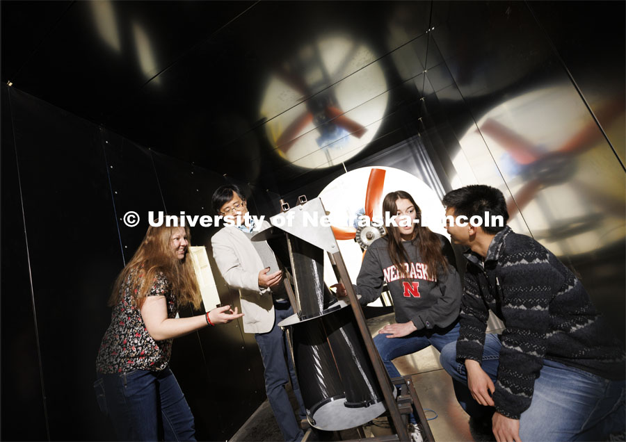 Wei Qiao demonstrates a wind turbine in the wind tunnel. College of Engineering photo shoot. March 30, 2022. Photo by Craig Chandler / University Communication.