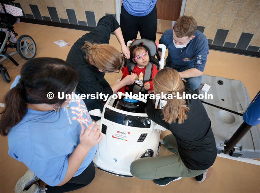 Four-year-old Dayana Torres is strapped into the new, battery-powered car that UNL and UNMC students modified for her. 

Twice yearly, Nebraska’s Go Baby Go chapter modifies kid-sized battery powered cars for children with movement difficulties, providing them at no cost to the families. Nebraska’s GoBabyGo! chapter is funded by the Munroe-Meyer Guild. The program is a partnership between MMI's Department of Physical Therapy, the University of Nebraska-Lincoln and the University of Nebraska-Omaha Engineering Department and the UNMC College of Allied Health Professions/Physical Therapy students. The event took place on at the MMI building at 69th and Pine Streets in Omaha on Saturday, April 2, 2022. Photo by Kent Sievers / University of Nebraska Medicine.

