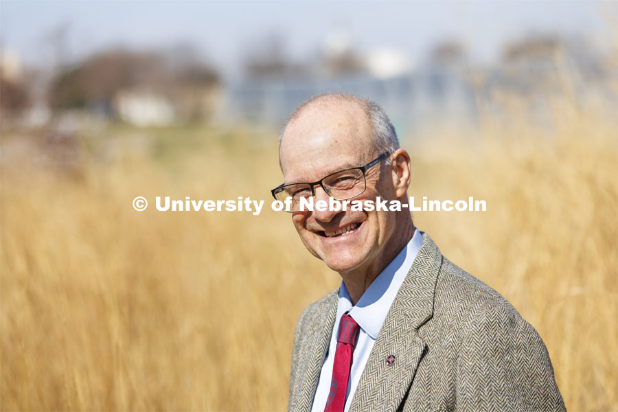 Robert Brooke, Professor of English,  is a 2022 OTICA winner His main teaching work has been in place-conscious education, so he was photographed in an outside space that might replicate Nebraska rurality. April 4, 2022. Photo by Craig Chandler / University Communication.
