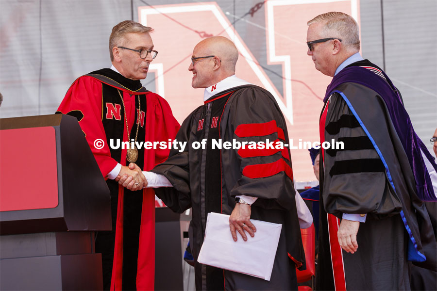 Jay Keasling, a professor of chemical engineering at University of California, Berkeley and a native of Harvard, Nebraska, is awarded an honorary degree by UNL Chancellor Ronnie Green with the assistance of NU Regent Timothy Clare. UNL undergraduate commencement in Memorial Stadium. May 14, 2022. Photo by Craig Chandler / University Communication.